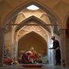 Manikins portraying a well-to-do man receiving a foot massage in a special portal after bathing while another worker is about to offer the guest a glass of tea